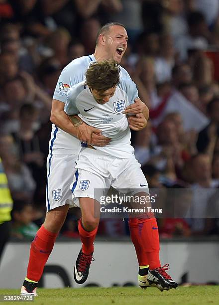 Paddy McGuinness and Louis Tomlinson celebrate after England beat Rest of the World during Soccer Aid 2016 at Old Trafford on June 5, 2016 in...