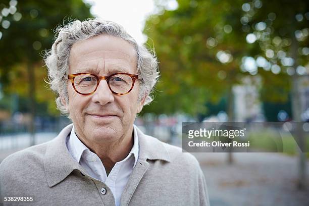 portrait of confident senior man outdoors - älterer mann stock-fotos und bilder