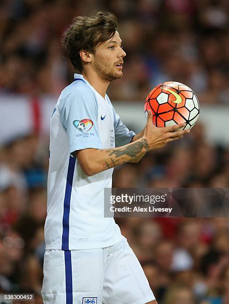 Louis Tomlinson of England takes a throw in during the Soccer Aid 2016 match in aid of UNICEF at Old Trafford on June 5, 2016 in Manchester, England.