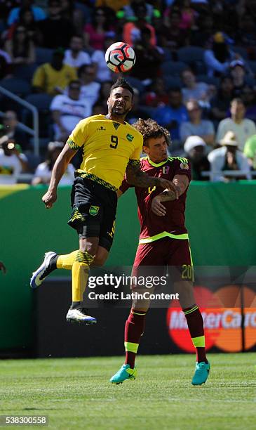 Giles Barnes of Jamaica and Rolf Feltscher of Venezuela during a group C match between Jamaica and Venezuela at Soldier Field Stadium as part of Copa...