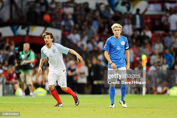 Louis Tomlinson and Niall Horanat play during Soccer Aid at Old Trafford on June 5, 2016 in Manchester, England.