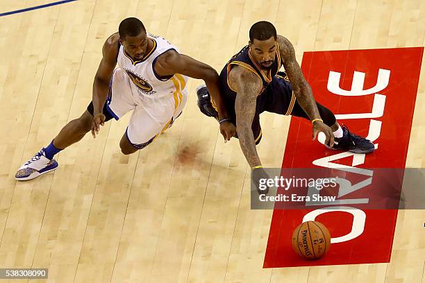 Smith of the Cleveland Cavaliers and Harrison Barnes of the Golden State Warriors dive for a loose ball during Game 2 of the 2016 NBA Finals at...