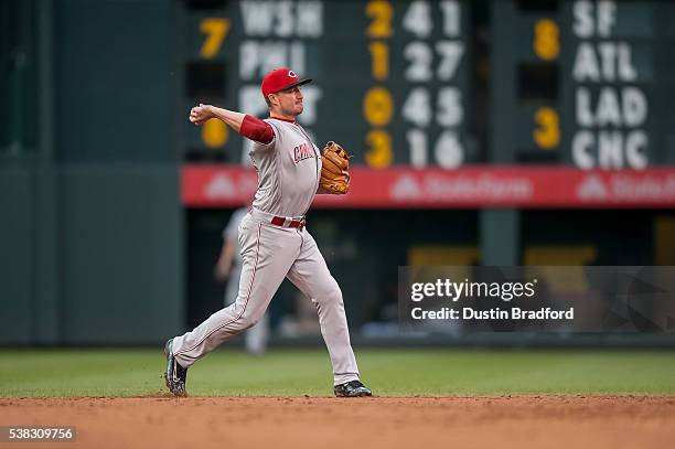 Jordan Pacheco of the Cincinnati Reds puts out a runner against the Colorado Rockies at Coors Field on May 31, 2016 in Denver, Colorado.