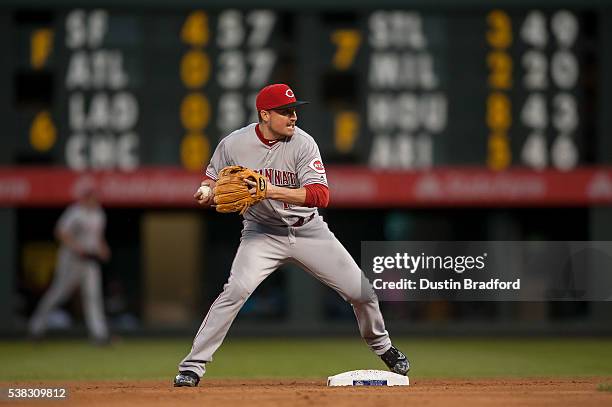 Jordan Pacheco of the Cincinnati Reds steps on second and turns to first for a double play against the Colorado Rockies at Coors Field on May 31,...