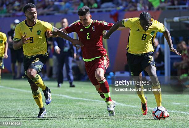 Giles Barnes of Jamaica, Wuilker Angel of Venezuela and Clayton Donaldson of Jamaica chase down the ball during a match in the 2016 Copa America...