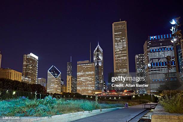 skyscrapers along millennium park, chicago - city night stock illustrations