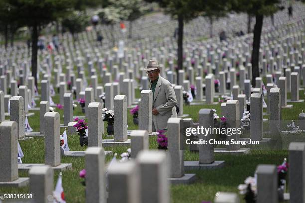 Man visits the grave of a relative who died during the Korean War at the Seoul national cemetary on June 6, 2016 in Seoul, South Korea. South Korea...