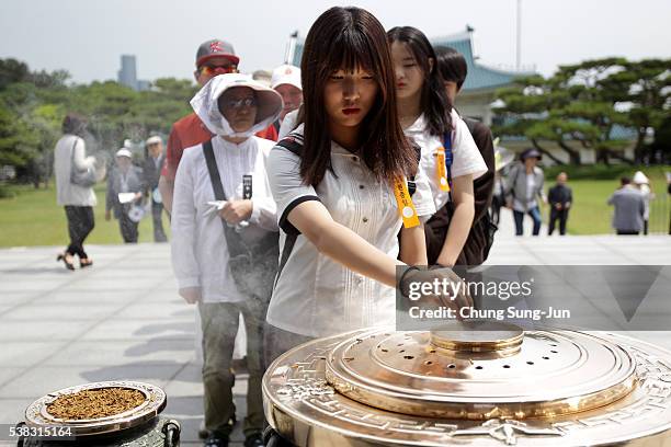 South Koreans burn incense during a ceremony marking Korean Memorial Day at the Seoul National cemetery on June 6, 2016 in Seoul, South Korea. South...