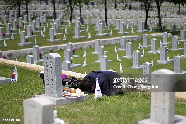 Woman visits the grave of a relative who died during the Korean War at the Seoul national cemetary on June 6, 2016 in Seoul, South Korea. South Korea...