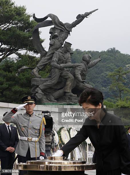 President Park Geun-Hye of South Korea burns incense during a ceremony marking Korean Memorial Day at the Seoul National cemetery on June 6, 2016 in...