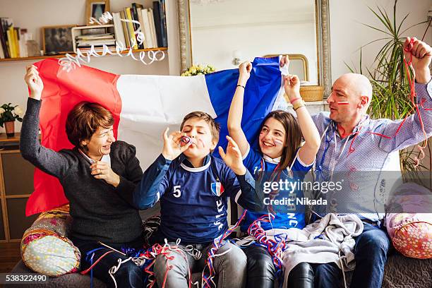 french family celebrating soccer event at home - france supporter stock pictures, royalty-free photos & images