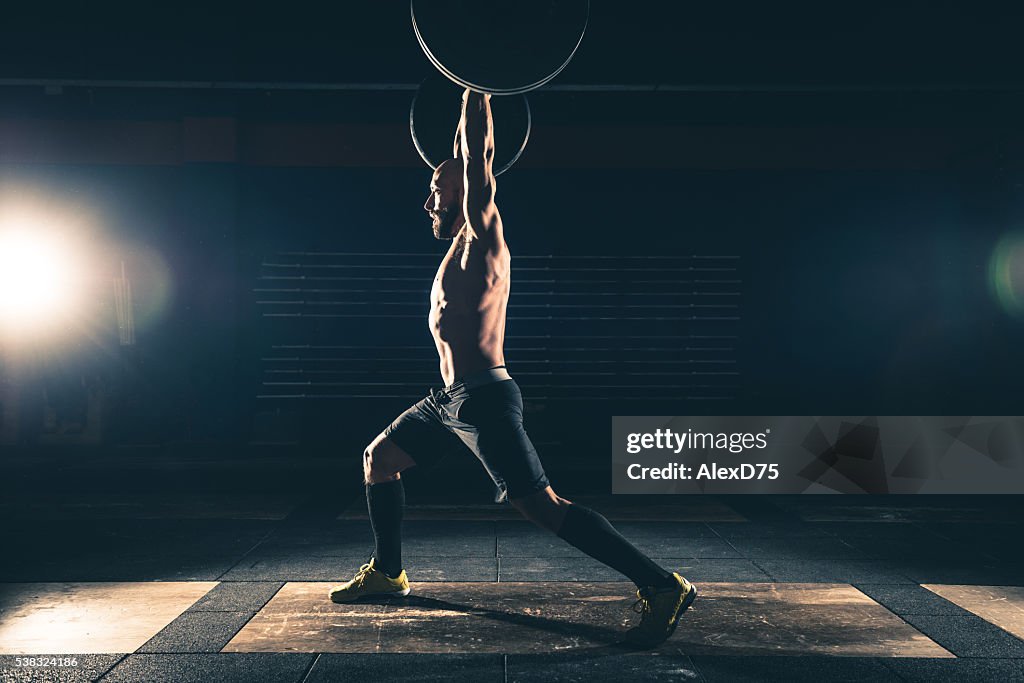 Weightlifting strong man on a gym