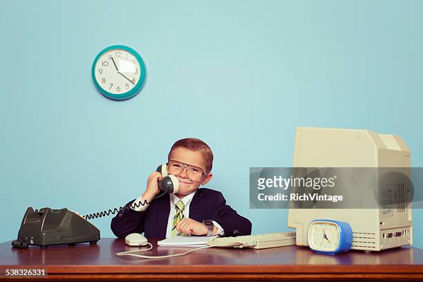 young boy businessman talks on the telephone - iconic technology from stock pictures, royalty-free photos & images