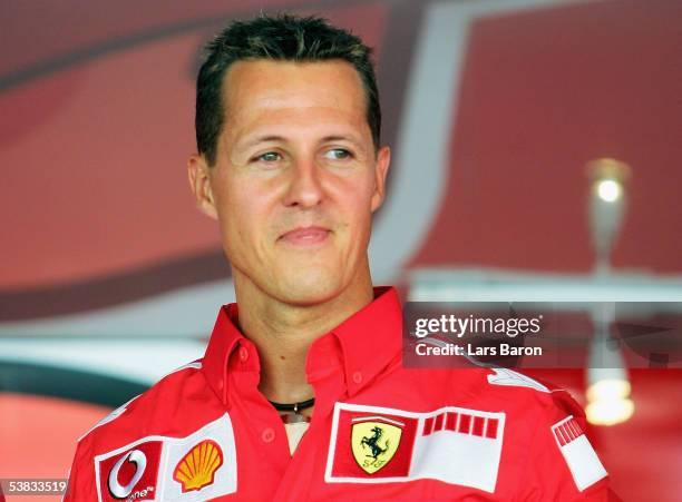 Michael Schumacher of Germany and Ferrari smiles after the Vodafone Race on Piazza Duomo in Milan during the preview to the Italian F1 Grand Prix on...