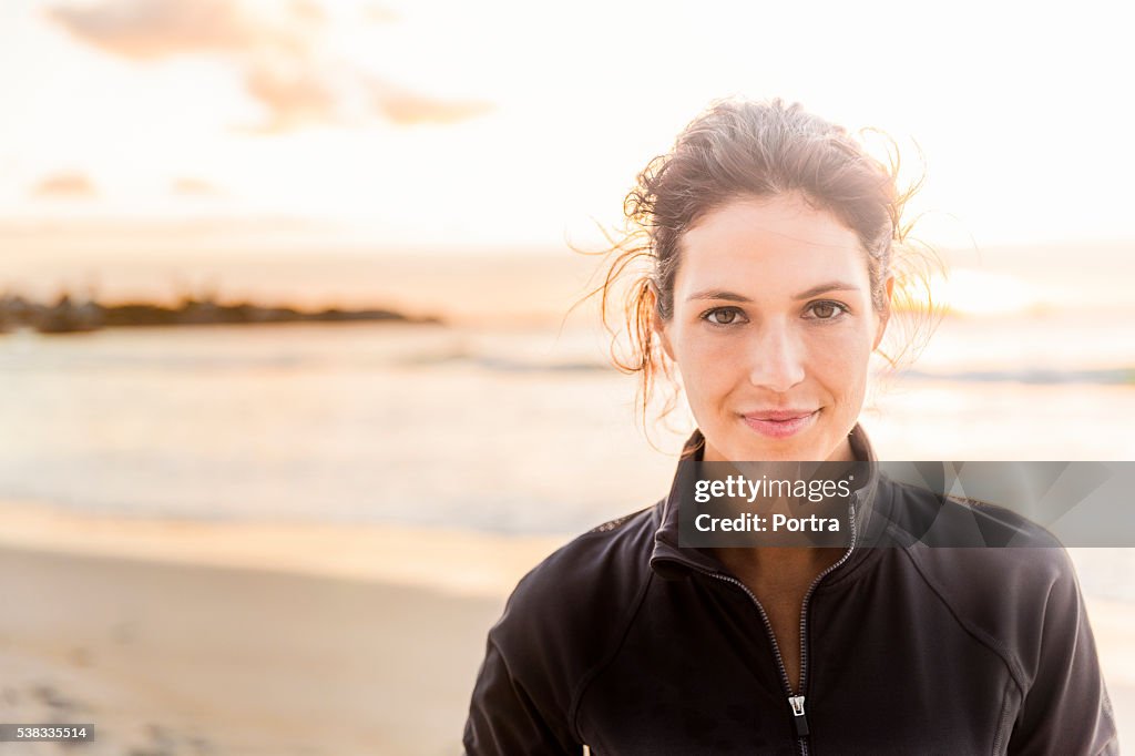 Confident sporty woman at beach