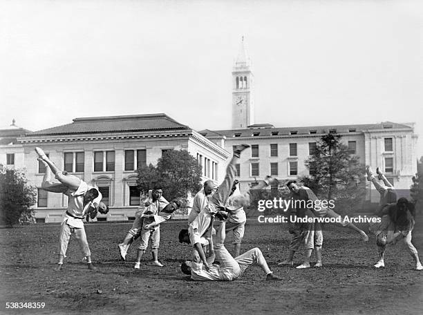 Martial arts class practices on the University of California campus with the Campanile rising in the background, Berkeley, California, circa 1900.