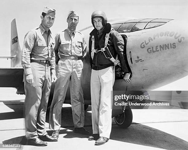 Standing left to right alongside of the Bell XS-1 rocket research airplane, 'Glamorous Glennis' are: Captain Charles E Yeager, Major Gus Lundquist...