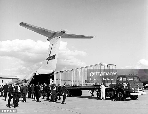 Freight container measuring 8'x8'x40' being loaded directly into a Lockheed C-141 Starlifter as it prepares to go on a world tour of the Free World,...