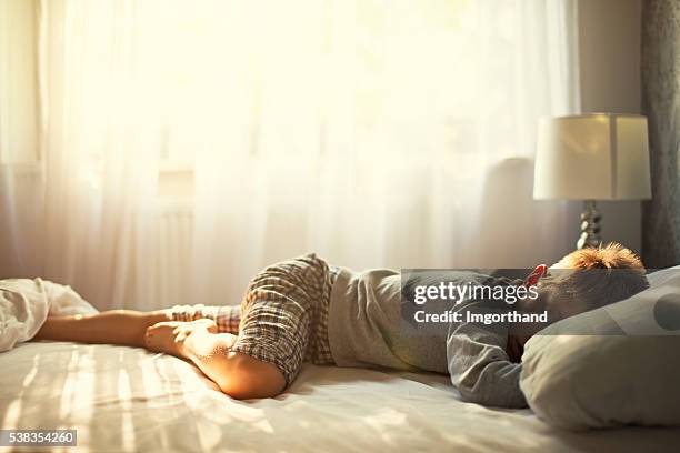 little boy sleeping on sunny morning. - comfortable bed stock pictures, royalty-free photos & images
