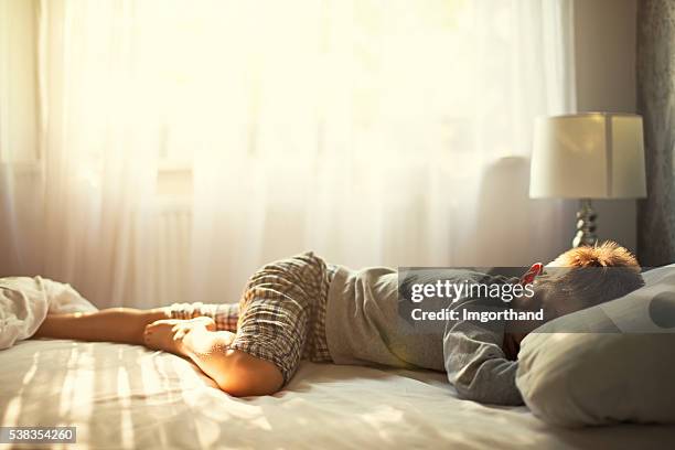 little boy sleeping on sunny morning. - comfortable stock pictures, royalty-free photos & images