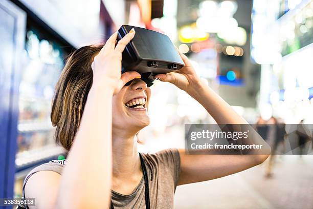 college student woman using the vr simulator in tokyo - travelgame stock pictures, royalty-free photos & images