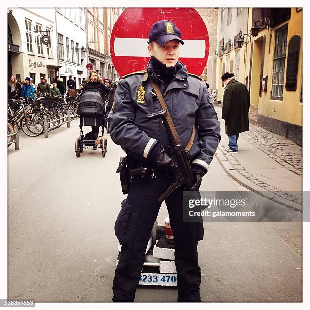 police officer guarding synagogue in copenhagen - terrorisme stockfoto's en -beelden