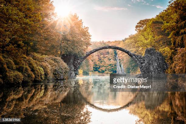 arch bridge (rakotzbrucke) at autumn - saxony stock pictures, royalty-free photos & images