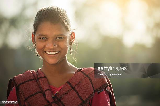 happy indian girl giving toothy smile and looking at camera. - girls stock pictures, royalty-free photos & images