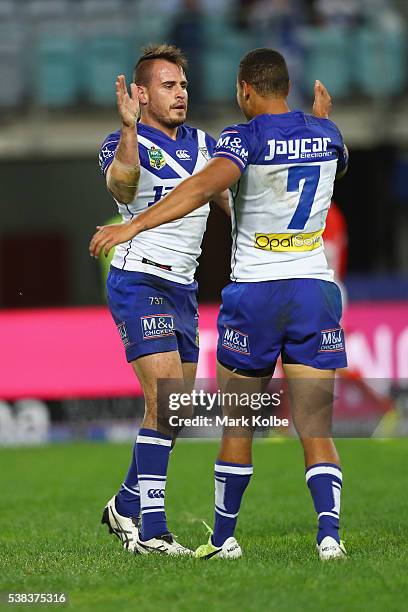 Josh Reynolds of the Bulldogs celebrates with Moses Mbye of the Bulldogs after scoring a try during the round 13 NRL match between the Canterbury...