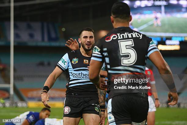 Jack Bird of the Sharks runs to celebrate with Valentine Holmes of the Sharks after he scored a try during the round 13 NRL match between the...