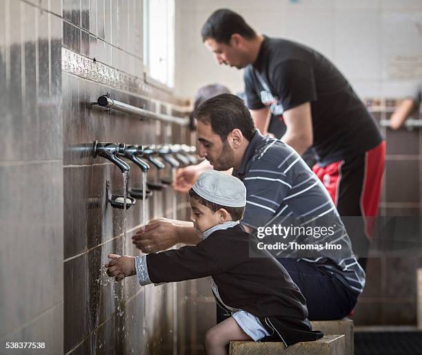 Sweileh, Jordan A Muslim father and his little son during the ritual ablution before prayer in the Shishan mosque on April 08, 2016 in Sweileh,...