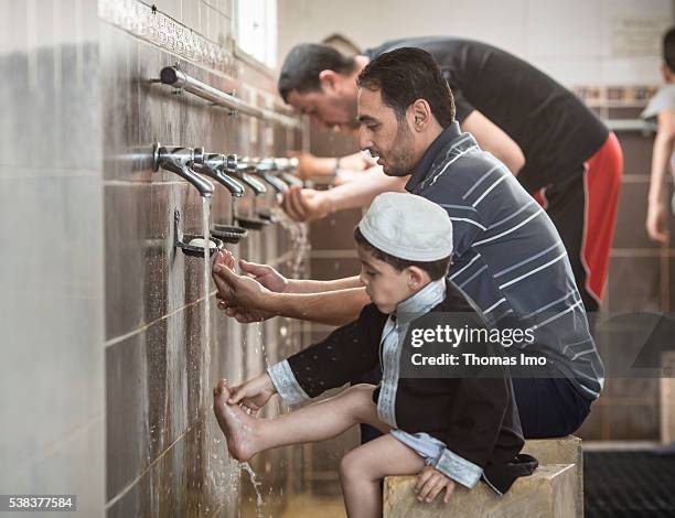 Sweileh, Jordan A Muslim father and his little son during the ritual ablution before prayer in the Shishan mosque on April 08, 2016 in Sweileh,...