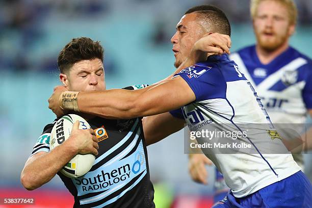 Chad Townsend of the Sharks is tackled by Raymond Faitala of the Bulldogs during the round 13 NRL match between the Canterbury Bulldogs and the...