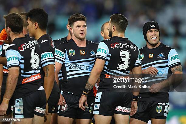 Chad Townsend and Michael Ennis of the Sharks watch the replay as they wait for the video referee decision during the round 13 NRL match between the...