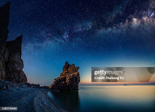 starry night over rock formations by the pacific ocean - long exposure night sky stock pictures, royalty-free photos & images