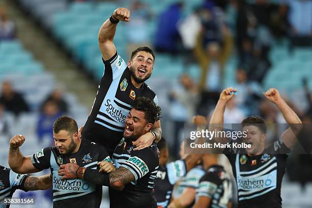 Wade Graham, Jack Bird, Andrew Fifita and Chad Townsend of the Sharks celebrate victory during the round 13 NRL match between the Canterbury Bulldogs...