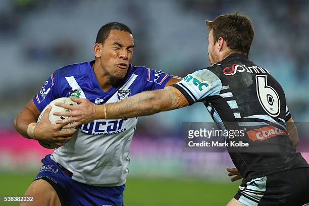 William Hopoate of the Bulldogs fends off James Maloney of the Sharks during the round 13 NRL match between the Canterbury Bulldogs and the Cronulla...