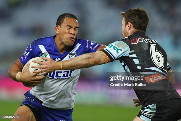 William Hopoate of the Bulldogs fends off James Maloney of the Sharks during the round 13 NRL match between the Canterbury Bulldogs and the Cronulla...