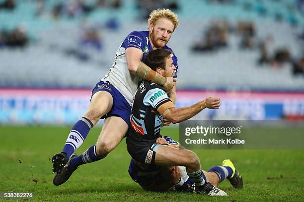 James Graham of the Bulldogs tackles James Maloney of the Sharks during the round 13 NRL match between the Canterbury Bulldogs and the Cronulla...