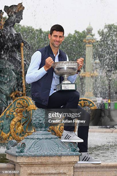 Novak Djokovic of Serbia poses with the winners trophy at Place de La Concorde on June 6, 2016 in Paris, France.