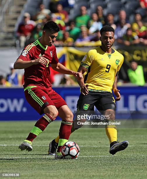 Wilker Angel of Venezuela looks to pass against Giles Barnes of Jamaica during a match in the 2016 Copa America Centenario at Soldier Field on June...
