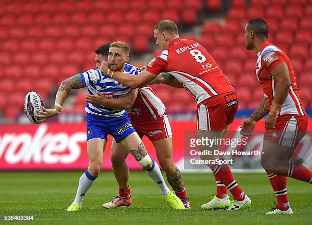 Wigan Warriors' Sam Tomkins comes under pressure from Salford Red Devils' Craig Kopczak during the First Utility Super League Round 17 match between...