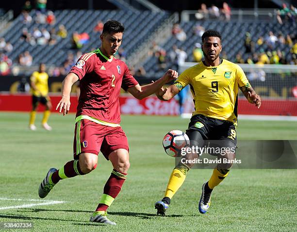 Giles Barnes of Jamaica and Wilker Angel of Venezuela go for the ball during a group C match between Jamaica and Venezuela at Soldier Field Stadium...