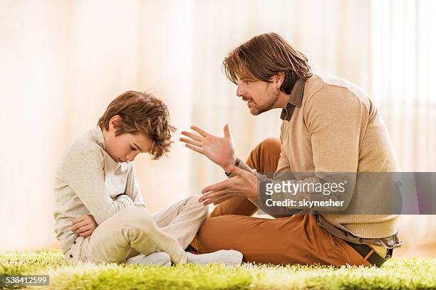 father scolding his son. - scolding stock pictures, royalty-free photos & images