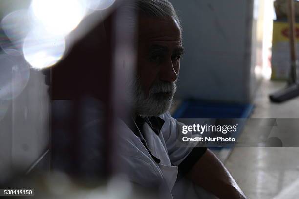 Abu Saeed at the age of 50 years running one of the charity kitchens during Ramadan Mubarak's. Abu Saeed big man age he worked before the war on the...