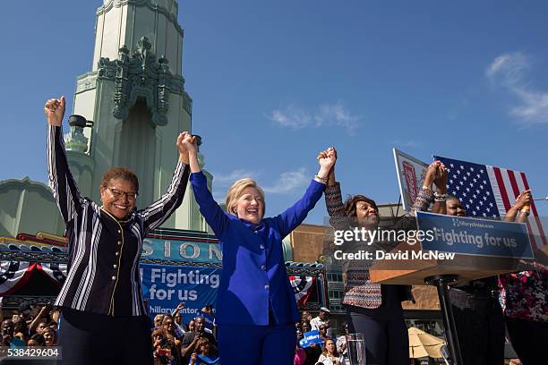 Democratic presidential candidate Hillary Clinton raises hands with others onstage at the South Los Angeles Get Out The Vote Rally at Leimert Park...