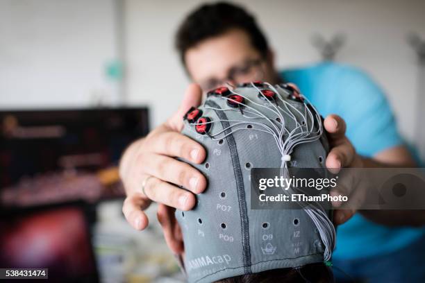 experiment with brain-computer interface (bci) in neuroscience laboratory - electrode stock pictures, royalty-free photos & images