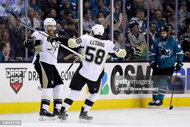 Ian Cole of the Pittsburgh Penguins celebrates with Kris Letang after scoring against the San Jose Sharks in the first period of Game Four of the...