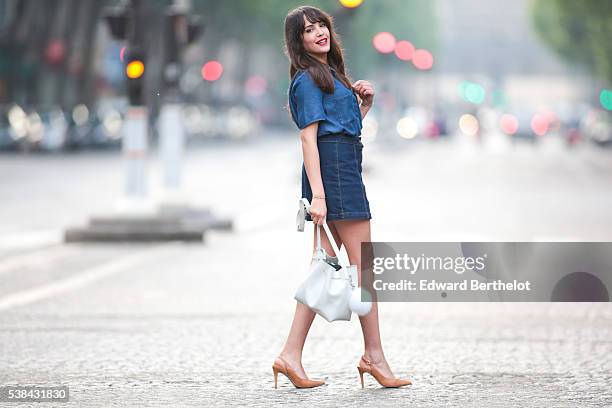 Sarah Benziane , is wearing a Zara blue shirt, a New Look blue skirt, Texto nude shoes, a Lancaster white bag, and a Michael Kors pompom, during a...