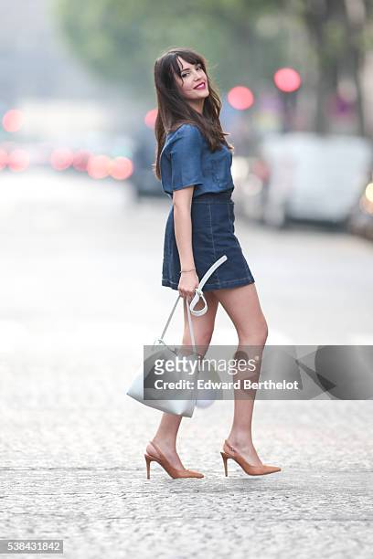 Sarah Benziane , is wearing a Zara blue shirt, a New Look blue skirt, Texto nude shoes, a Lancaster white bag, and a Michael Kors pompom, during a...